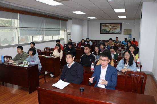 A group of people sitting at a tableDescription automatically generated with low confidence